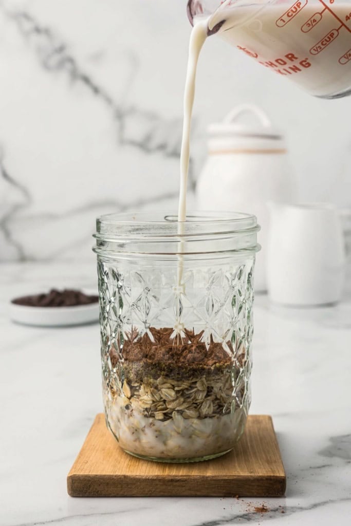 milk, oats, and cocoa powder in a mason jar