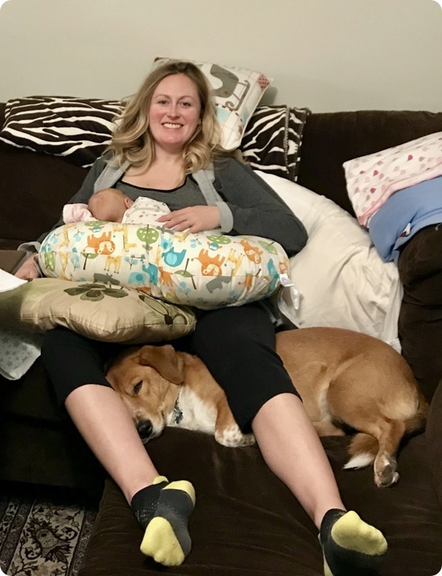 feeding baby with dog helping