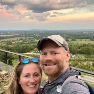 anne and matt mauney with a sunset view