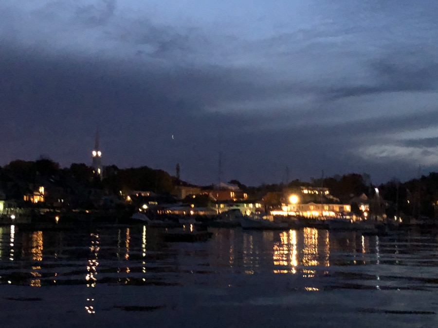 blurry view of camden waterfront from the water at dark