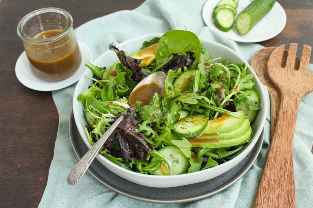 green salad in a bowl with homemade lemon balsamic dressing