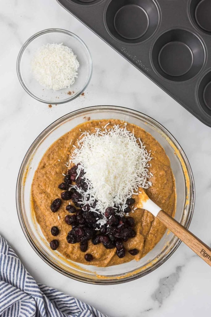 muffin batter with dried cranberries and shredded coconut mixed in