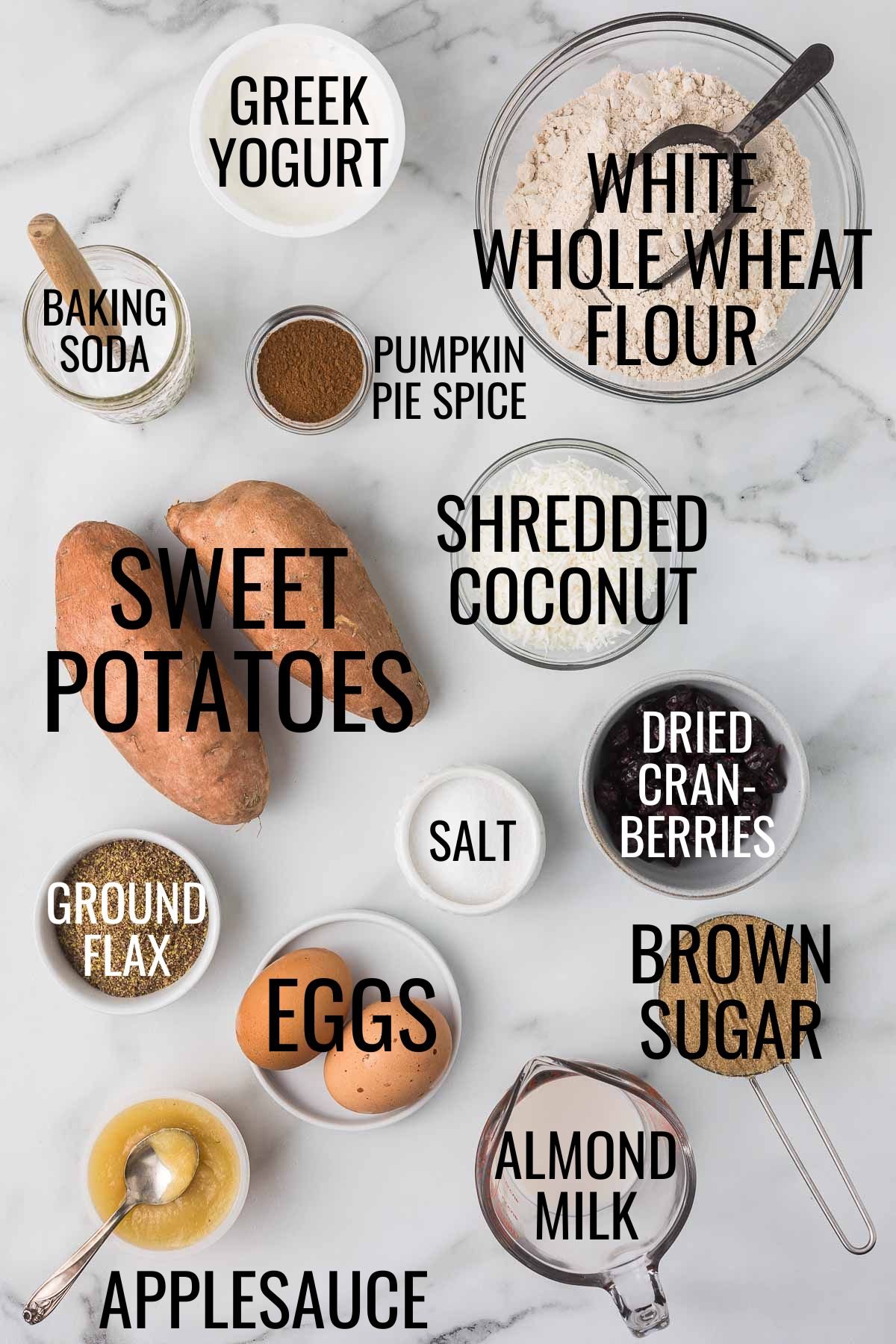 sweet potatoes, white whole wheat flour, Greek yogurt, eggs, applesauce, almond milk, brown sugar, and more baking ingredients on a white marble countertop